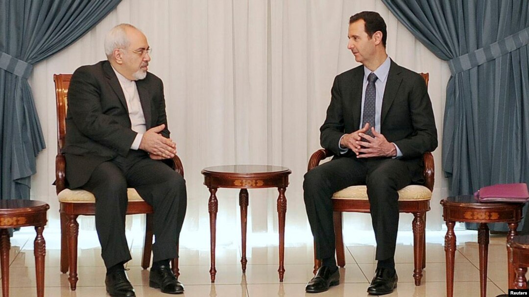 Syrian President Bashar al-Assad (right) meets with Iranian Foreign Minister Mohammad Javad Zarif in Damascus on January 15.