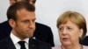 France's President Emmanuel Macron and Germany’s Chancellor Angela Merkel during a news conference at the G20 summit in Osaka
