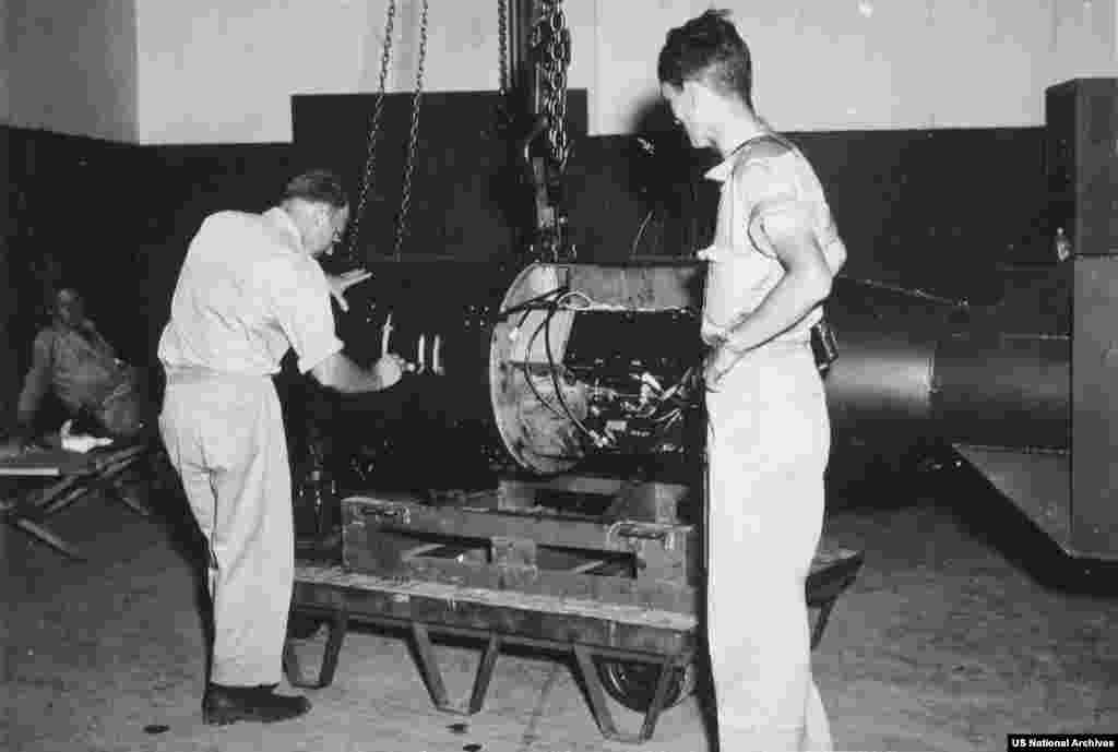 The atomic bomb dubbed “Little Boy” being inspected after assembly on Tinian Island in August 1945.Amid strict secrecy, parts for the first nuclear weapon to be used in combat were separately shipped and flown to Tinian in July 1945 where the bomb was assembled.