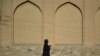 AFGHANISTAN -- An Afghan woman walks through a street in Kabulm September 13, 2021