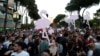 Protesters hold cartoon flamingos as they gather in in Tirana on June 10 to demonstrate against the construction of a luxury resort near a protected natural area on the southern coast of Albania.