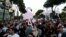 Protesters hold cartoon flamingos as they gather in in Tirana on June 10 to demonstrate against the construction of a luxury resort near a protected natural area on the southern coast of Albania.