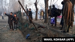 Afghan residents gather at the site of a suicide attack in Kabul on January 5.