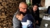 Jablanica, Bosnia -- An evacuee from the flooded areas with his child