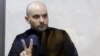 Andrei Pivovarov gestures from behind the glass during a court hearing in Krasnodar on June 2.