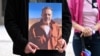 A protester outside Germany's Foreign Ministry holds a picture of Jamshid Sharmahd in July 2023. (file photo)