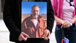 A protester outside Germany's Foreign Ministry holds a picture of Jamshid Sharmahd in July 2023. (file photo)