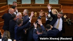 Kosovar lawmaker Time Kadriaj throws an egg at Prime Minister Albin Kurti (not pictured) during a plenary session to elect the new speaker of the parliament in Pristina on August 8