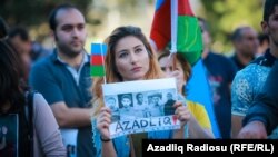 The crowd at the Baku rally held aloft Azerbaijani flags and photographs of people believed to be political prisoners. 