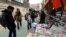Iranians look at newspapers displayed on the ground outside a kiosk in a street of Tehran, Iran, 24 November 2013.