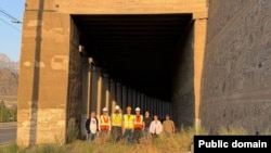 Armenia - Engineers from the U.S. consulting firm AECOM pose for a photograph by a disused railway tunnel on Armenia's border with Iran.
