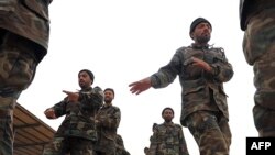 Afghan soldiers take part in combat training at the Afghan National Army training camp on the outskirts of Kandahar.