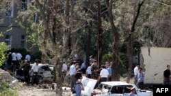 Police officers examine the scene after the attack