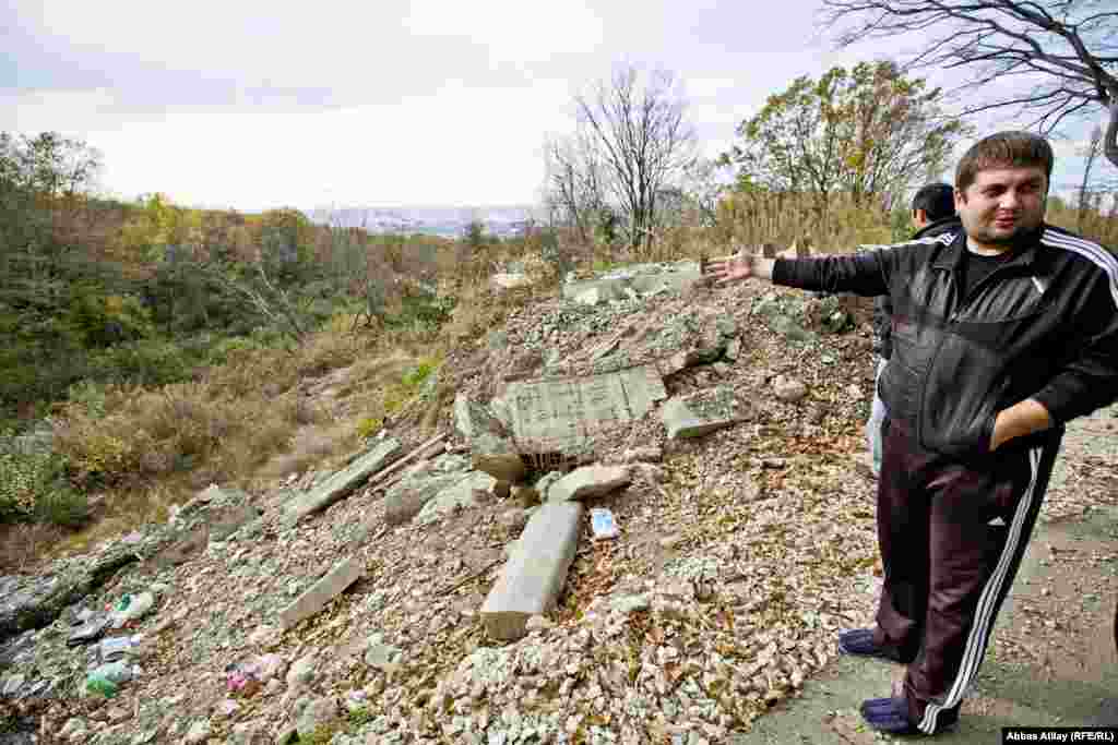 A short drive uphill from his family home, Dmitry Abzhan, 27, points to the place where trucks illegally dumped waste, causing a landslide.