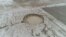 Iran - a sinkhole caused by land subsidence, caused by excessive ground water usage, caused by drought. AP video screen grab