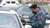 ARMENIA -- A police officer checks a driver's documents during a coronavirus lockdown as a preventive measure against coronavirus disease, in Yerevan, April 2, 2020