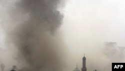 Smoke billows from the scene of one of the explosions in central Baghdad.
