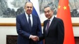 Russian Foreign Minister Sergei Lavrov (left) meets with Chinese Foreign Minister Wang Yi in Beijing on April 9.