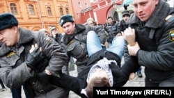 Police detain opposition activists near the closed entrance to Red Square 