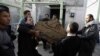 Iraqis retrieve body of a family member from morgue in Baghdad on November 23