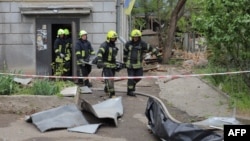 Ukrainian rescuers carry a body from a damaged building following an overnight drone attack in Odesa.