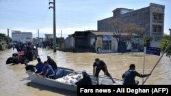 Residents of the northern Iranian village Agh Ghaleh are using a boat in a flooded street, on March 23, 2019.<br />
<br />
<br />
&nbsp;