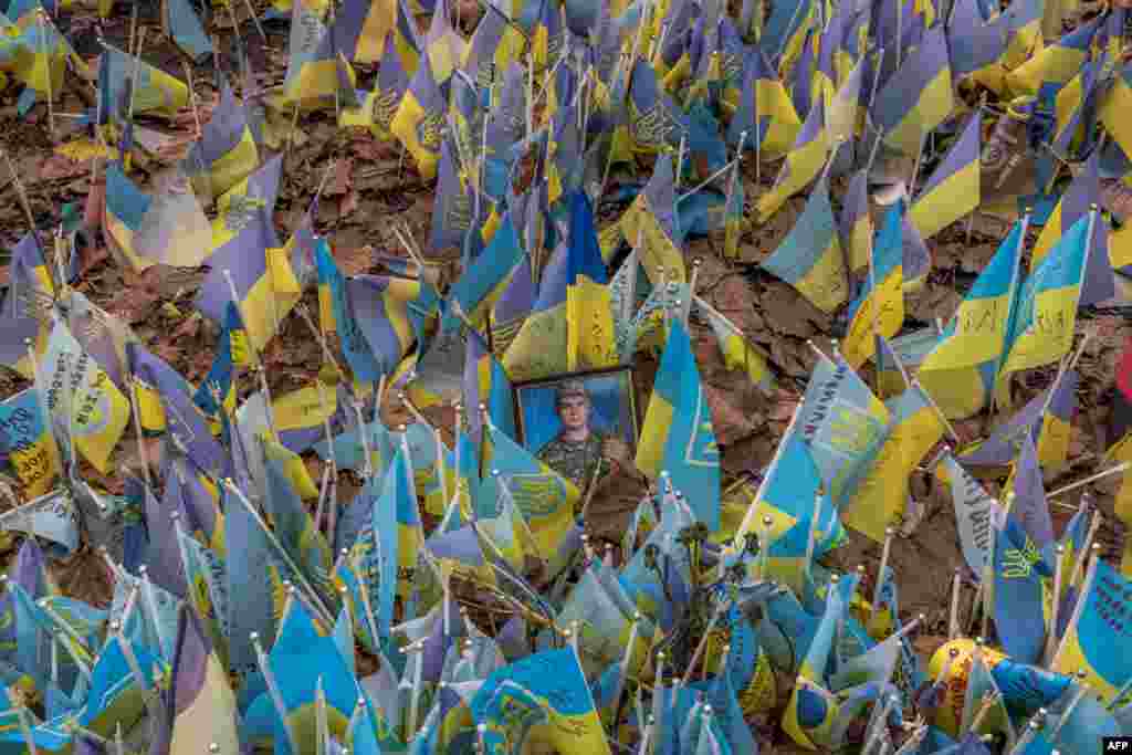 Flags bearing the symbols and colors of Ukraine are laid to commemorate fallen Ukrainian soldiers on Independence Square in Kyiv, on February 24.