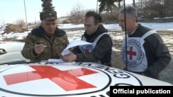 Armenia - An Armenian military official and representatives of the Red Cross prepare for the handover to Azerbaijan of the body of an Azerbaijani army soldier killed on the Armenian-Azerbaijani border on December 29, 5Feb2017.