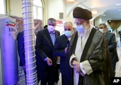 Supreme Leader Ayatollah Ali Khamenei (right) visits an exhibition of Iran's nuclear achievements at his office compound in Tehran in June 2023.