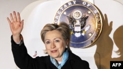 U.S. Secretary of State Hillary Clinton waves as she arrives on February 16 in Tokyo, the first stop of her Asian tour.