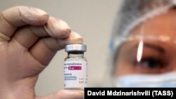 GEORGIA -- A health worker holds a vial of the AstraZeneca COVID-19 vaccine at the Infectious Diseases, AIFS and Clinical Immunology Research Center in Tbilisi, March 15, 2021