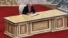 Alyaksandr Lukashenka signs a document after taking the oath of office during a hastily called "inauguration" in Minsk on September 23.