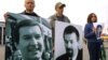 Protesters hold pictures of Belarusian opposition politician Viktar Hanchar (left) and businessman Anatol Krasouski. Both men have been missing since 1999. (file photo)