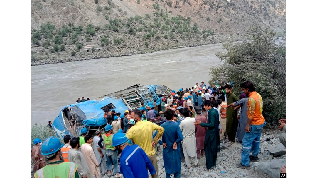 A bus lays in a ravine in northwest Pakistan on July 14 after a bus explosion killed 13 people, including nine Chinese workers at a nearby hydropower plant.