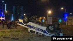 A police car is overturned during protests in Batumi, Georgia.