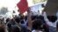 Around 200 demonstrators gathered in front of the parliament demanding the release of labor leader on hunger strike,