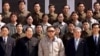 North Korean leader Kim Jong-il (in light jacket) poses with scientists and technicians at a purported satellite-control center after in April.