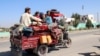 Residents flee Nadali district to Helmand's provincial capital, Lashkar Gah, during the ongoing clashes between Taliban fighters and Afghan security forces on October 14.