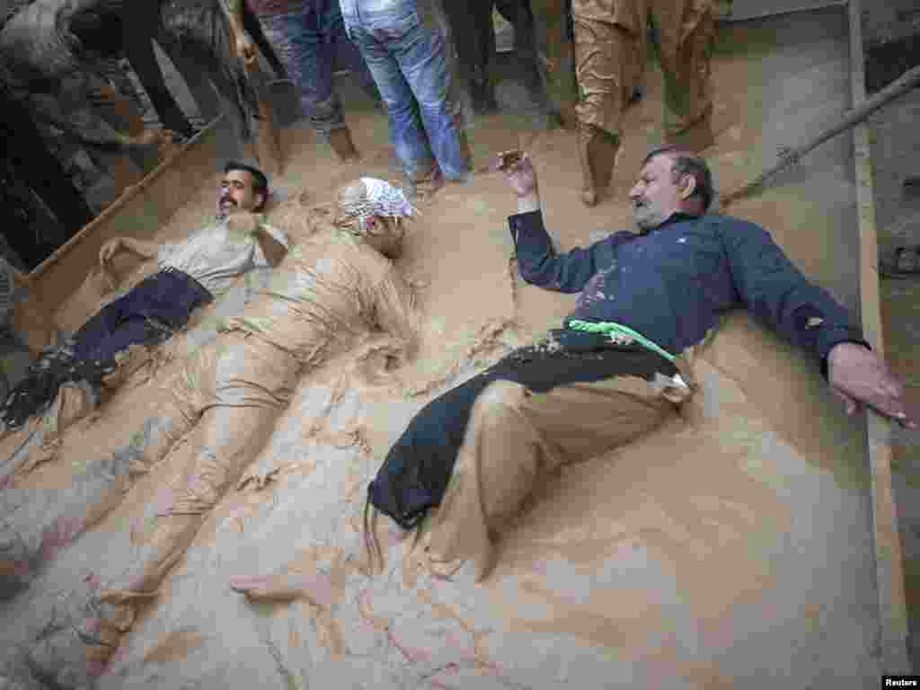 Men cover themselves in mud during the Ashura religious festival in Khorramabad, Iran, on December 16. Mourners cover themselves in mud to commemorate the death of Imam Hussein. Photo by Morteza Nikoubazl for Reuters