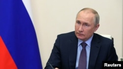 Russia's President Vladimir Putin chairs a meeting outside Moscow