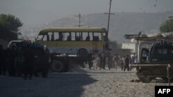 The minibus being taken away following the suicide attack in Kabul.