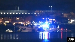 Part of the wreckage is seen as rescue boats search the waters of the Potomac River after a plane collided with a helicopter in Washington, DC, on January 30.