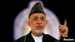 Afghanistan -- Afghan President Hamid Karzai speaks after voting in the presidential election in Kabul June 14, 2014. Afghans headed back to the polls on Saturday for a second round of voting to elect a successor to President Hamid Karzai in a decisive te