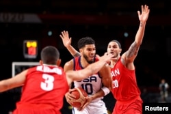 Jayson Tatum of the United States and Mike Rostampour of Iran compete during the men's basketball group-stage game at the Tokyo 2020 Olympics in Saitama, Japan, in July 2021.