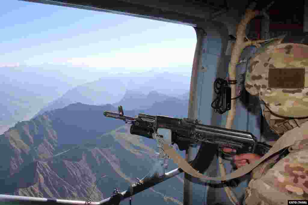 A serviceman from the Russian-led Collective Security Treaty Organization looks over the border area between Tajikistan and Afghanistan on July 5. Tajikistan has seen a surge of refugees fleeing across the border amid the recent Taliban advances.&nbsp;