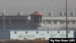Barbed-wire fences surround a government detention facility in China's Xinjiang region. 