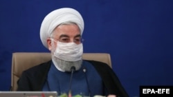 A handout photo made available by the presidential office shows Iranian President Hassan Rouhani wearing face mask during the cabinet meeting in Tehran, Iran, 08 July 2020.