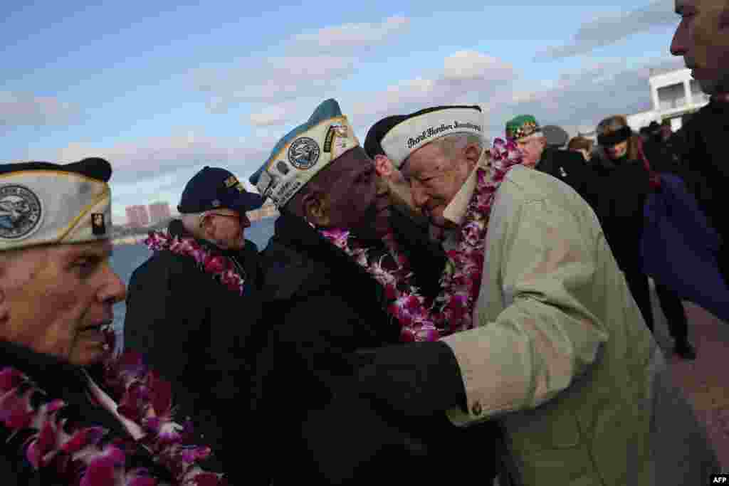 Pearl Harbor survivors embrace at a ceremony marking the 72nd anniversary of the attack on Hawaii on December 7. (Getty Immages/AFP/John Moore)