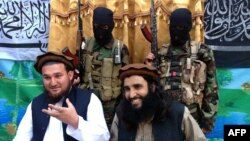 Tehreek-e-Taliban Pakistan (TTP) spokesman Ehsanullah Ehsan, left, and with TTP member Adnan Rasheed in 2013
