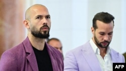 Andrew Tate (left) and his brother, Tristan Tate, outside an appeals court in Bucharest on December 10. 